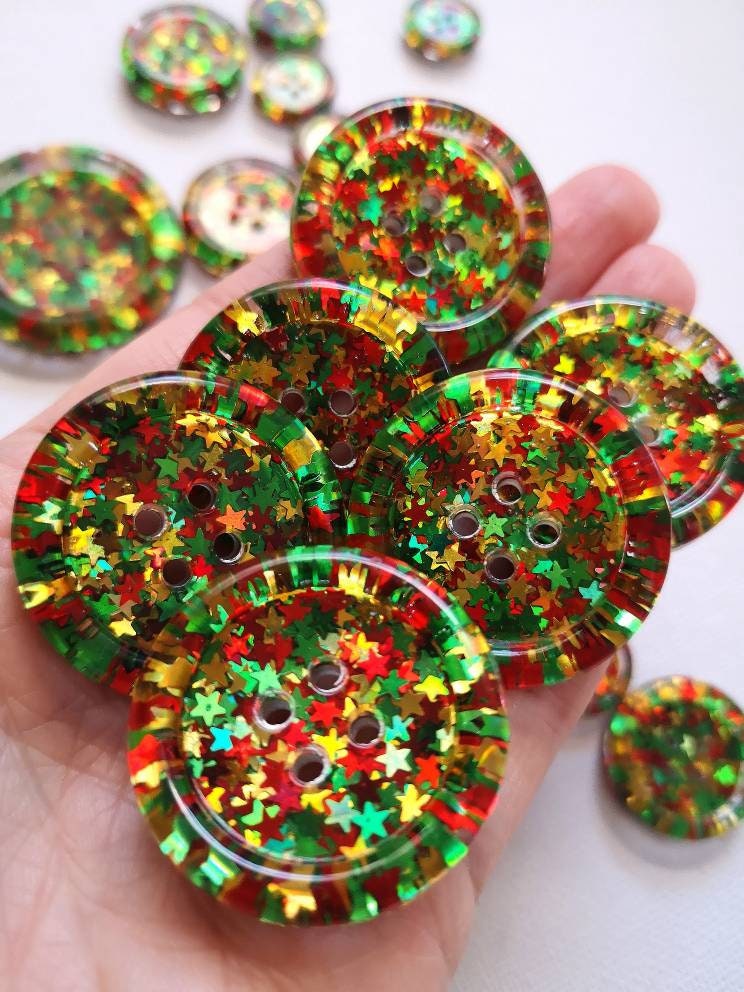 The Nadolig Llawen Button โ Welsh Christmas Resin Button with Red, Gold and Green Sparkle Stars