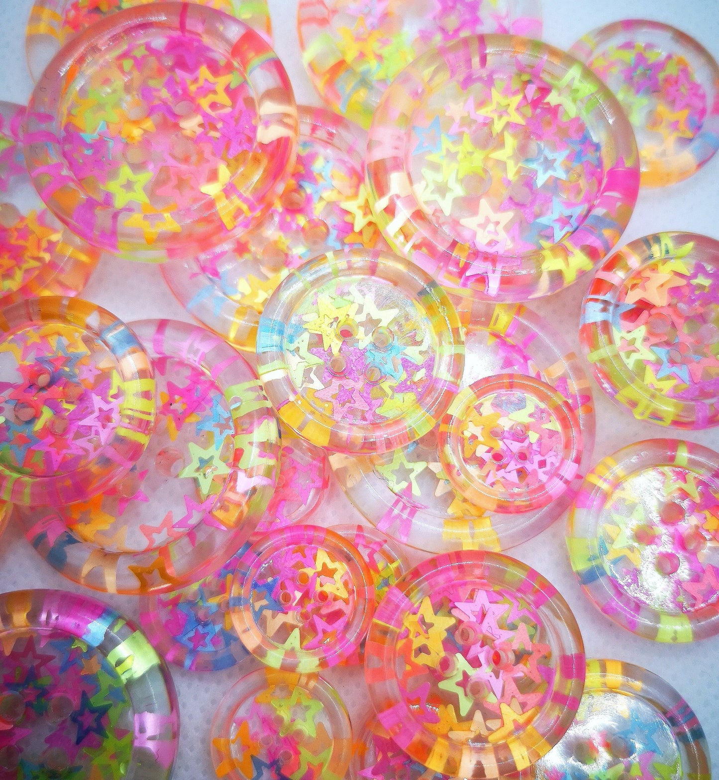 The Stars in Their Eyes button – Glossy Transparent Button with pearly Neon Star Magic