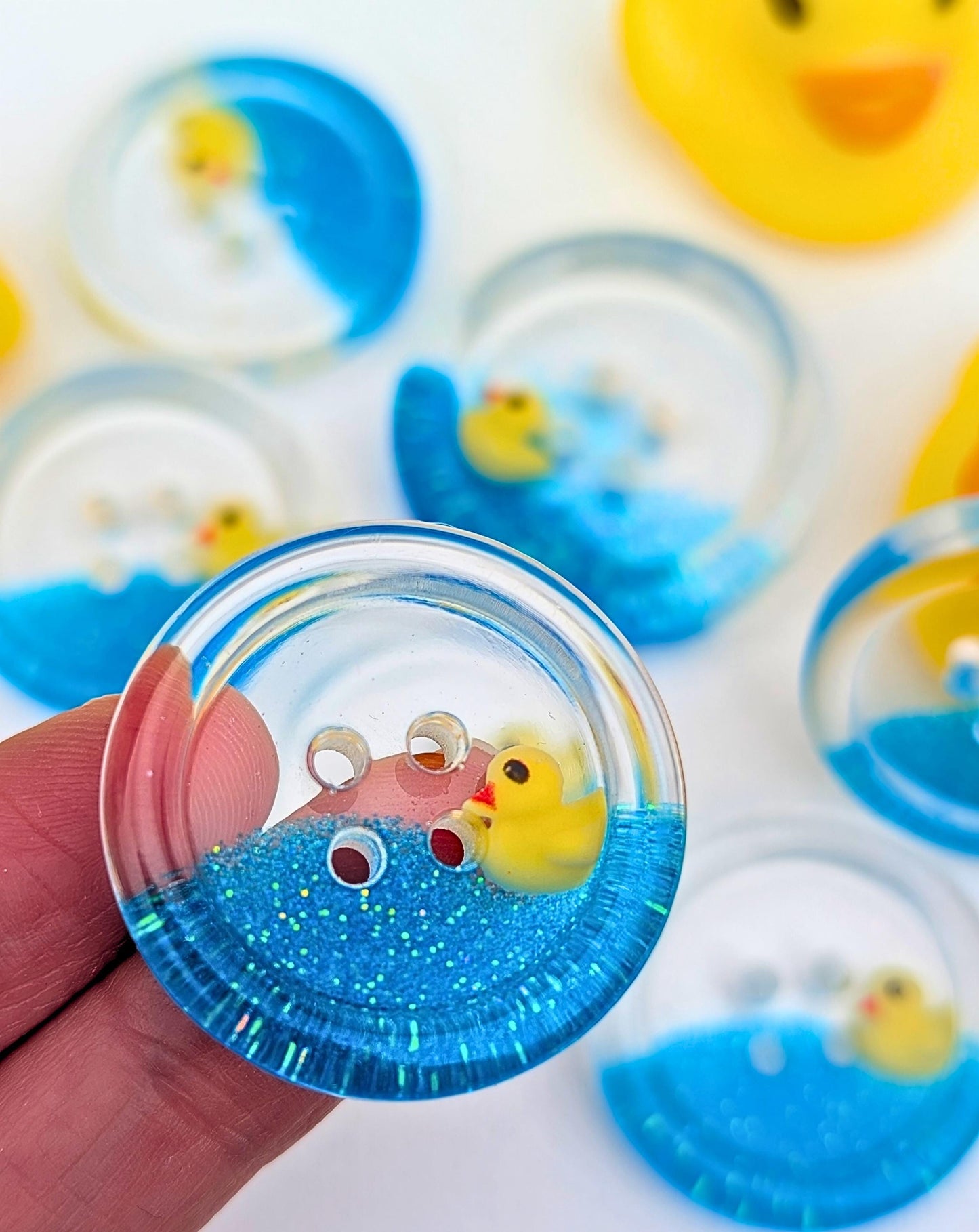The Feeling Ducky Button – Sparkly Blue Transparent Resin Button with Floating Rubber Duck