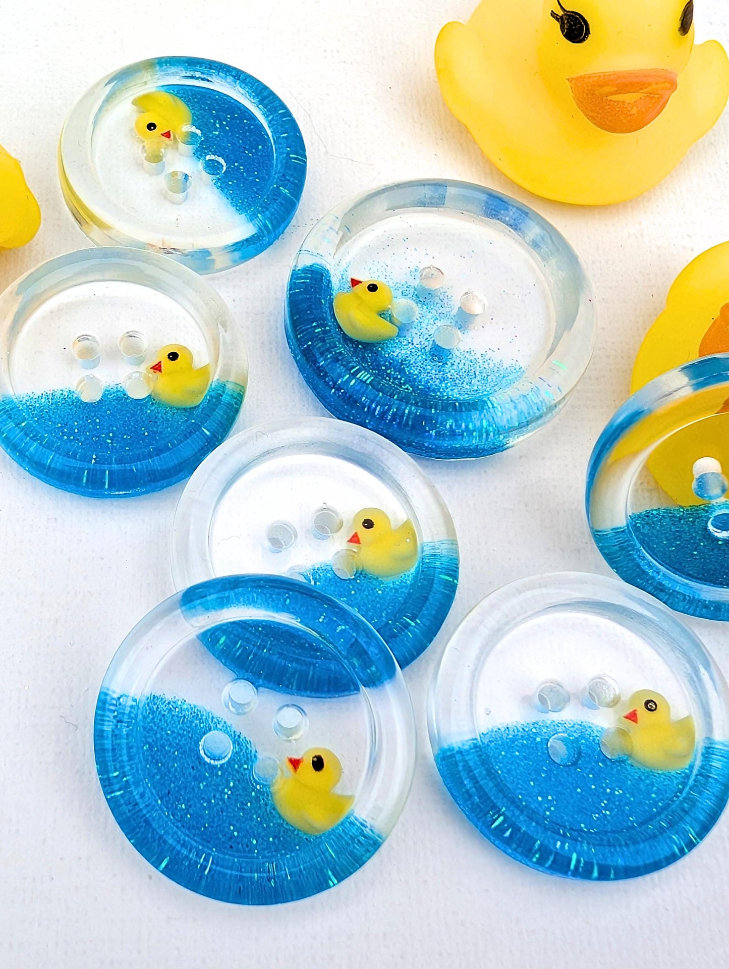 The Feeling Ducky Button – Sparkly Blue Transparent Resin Button with Floating Rubber Duck