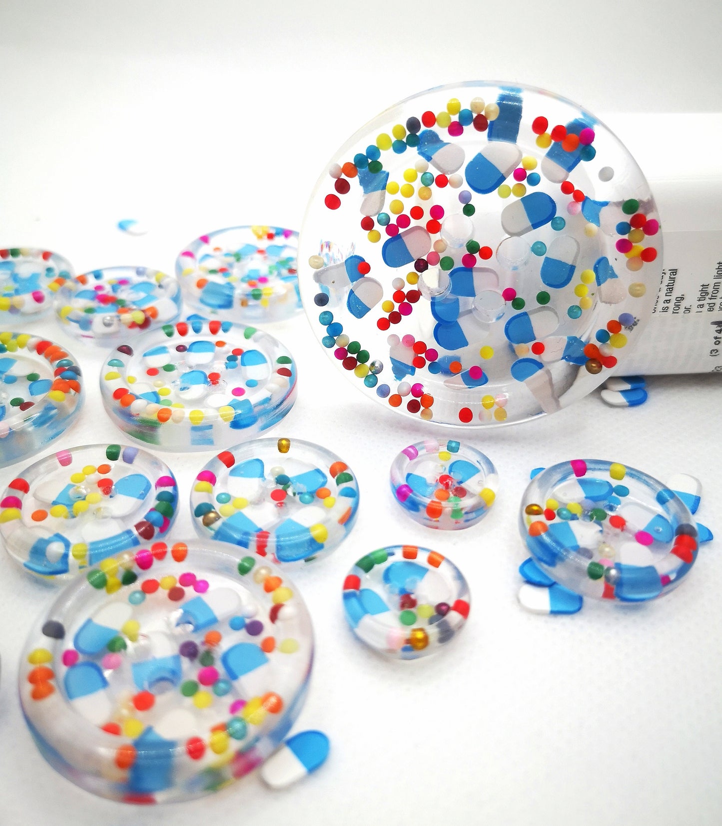 The Pharmacy. Clear handmade fake pill art buttons with rainbow dots