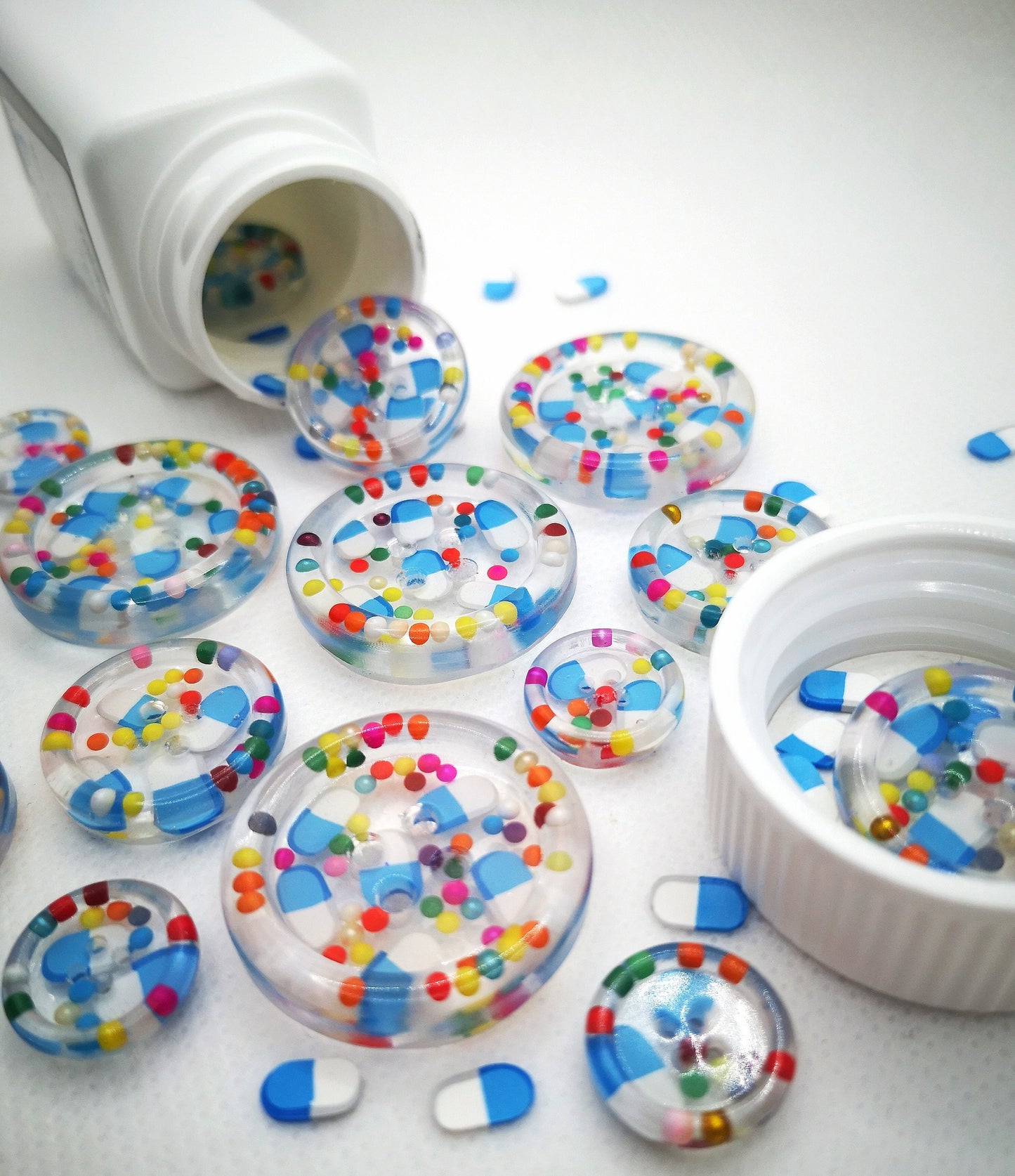 The Pharmacy. Clear handmade fake pill art buttons with rainbow dots