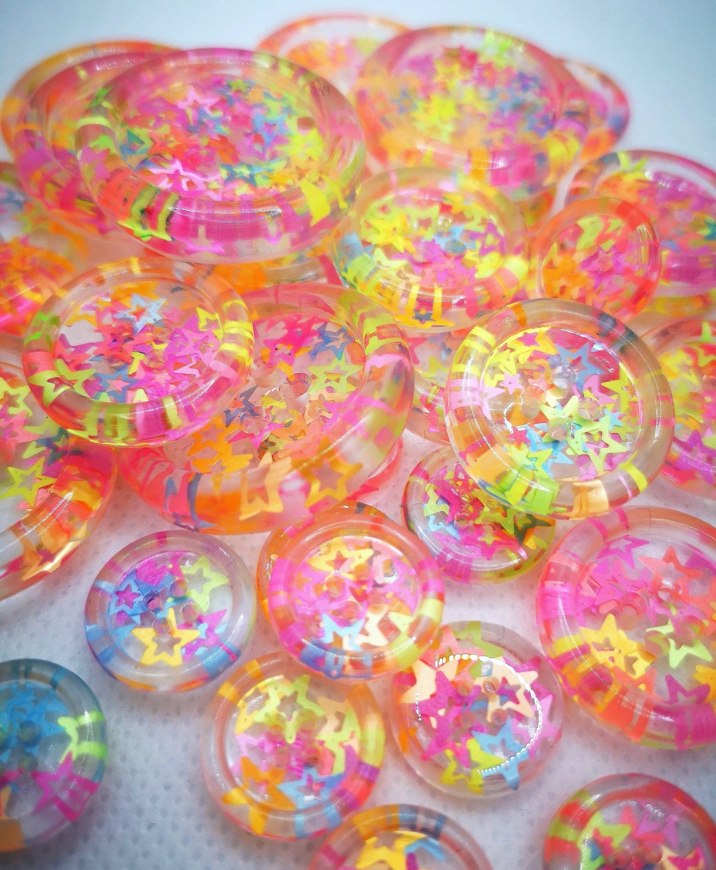The Stars in Their Eyes button – Glossy Transparent Button with pearly Neon Star Magic