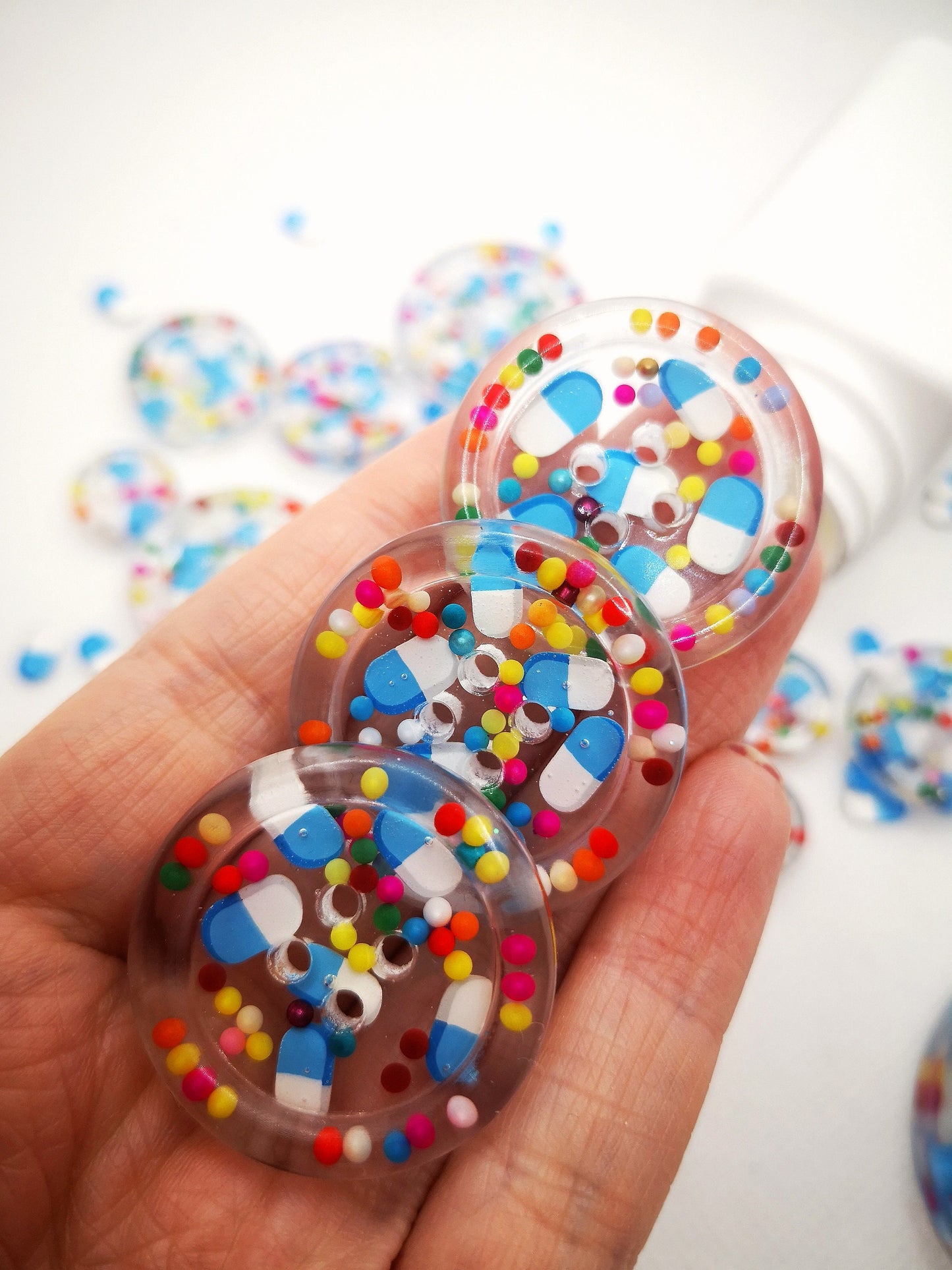 The Pharmacy. Clear handmade fake pill art buttons with rainbow dots