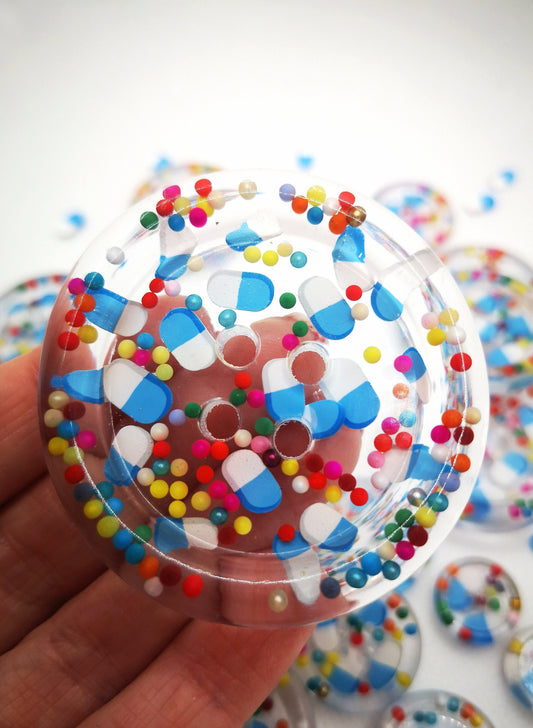 The Pharmacy. Clear handmade fake pill art buttons with rainbow dots